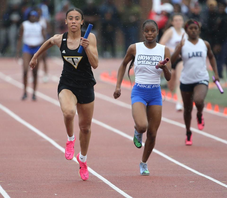 Tatnall's Arianna Montgomery (left) anchors her team to a win in the Division II 4x100 meter race during the second day of the DIAA state high school track and field championships at Dover High School, Saturday, May 18, 2024.