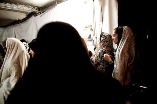 Iranian women queue up to vote in the first round of the presidential elections at a polling station in Tajrish square in northern Tehran, on June 14, 2013. Moderate cleric Hassan Rowhani, bolstered by a late surge in support from suppressed Iranian reformists, was leading the race on Saturday to succeed Mahmoud Ahmadinejad as president, initial election results showed