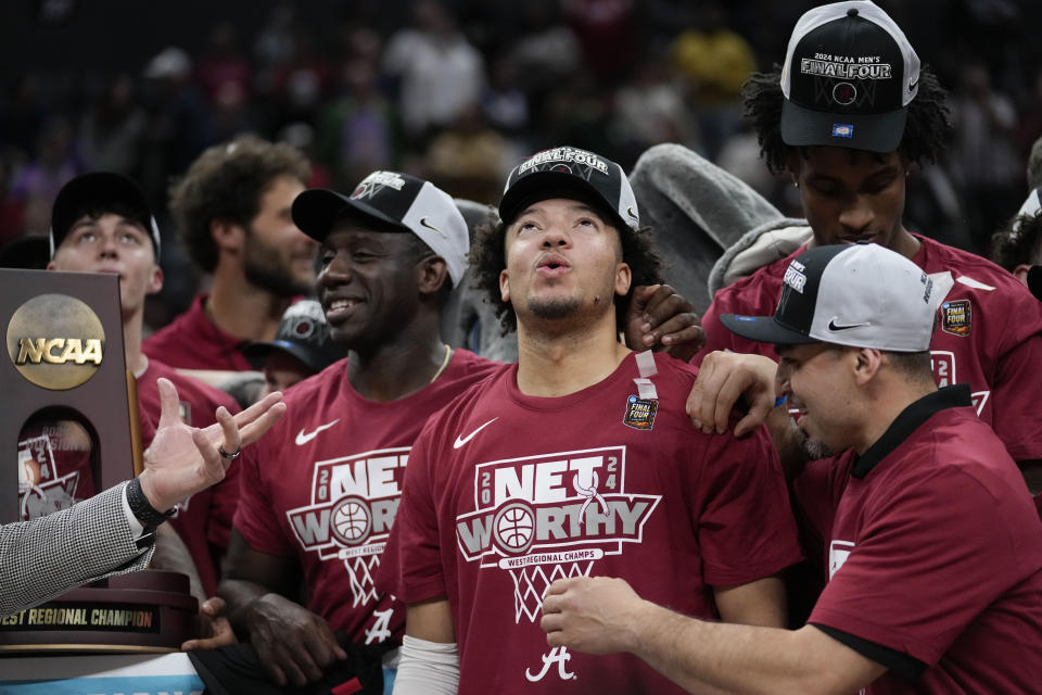 Alabama guard Mark Sears, center, celebrates after a win over Clemson in an Elite 8 college basketball game in the NCAA tournament Saturday, March 30, 2024, in Los Angeles. (AP Photo/Ashley Landis)