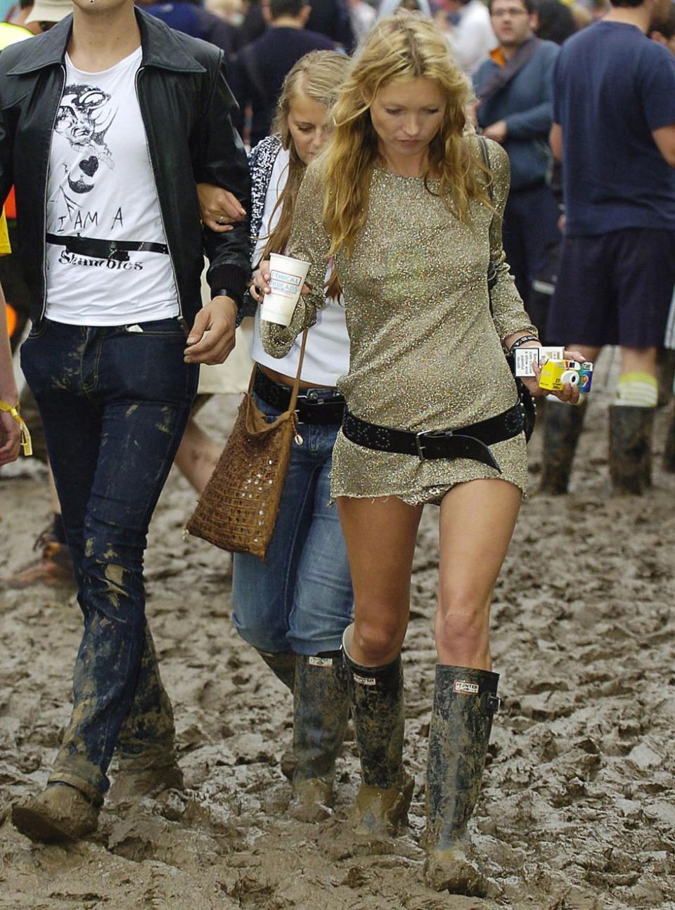 <p>The queen of cool, rocking a gold, sparkly mini dress and Hunter wellies covered in mud.</p>