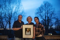 Jeff and Lola Carter stand with their daughter, Amanda, and a framed photo of Kayla, their daughter who struggled with drug addiction, Tuesday, March 16, 2021, at their home in Milton, W.Va. Kayla was hospitalized in June with endocarditis, a heart infection common among injection drug users. It seemed like she was suddenly determined to live. In October, her mother couldn't reach her one Friday. She went to her apartment, and found her dead on her bathroom floor. They are still waiting for the medical examiner's report, but her father would rather never see it. It brings him comfort to think she died from a complication from her surgeries, and not that she relapsed and overdosed. Either way, the drugs killed her, he said. "The only thing about any of it gives me any relief at all," he says, "is knowing we're not the only ones." (AP Photo/David Goldman)