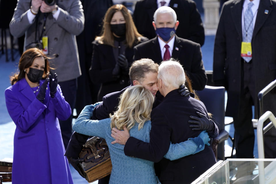 President Joe Biden hugs first lady Jill Biden, his son Hunter Biden and daughter Ashley Biden after being sworn-in during the 59th Presidential Inauguration at the U.S. Capitol in Washington, Wednesday, Jan. 20, 2021. Vice President Kamala Harris applauds at left. (AP Photo/Carolyn Kaster)