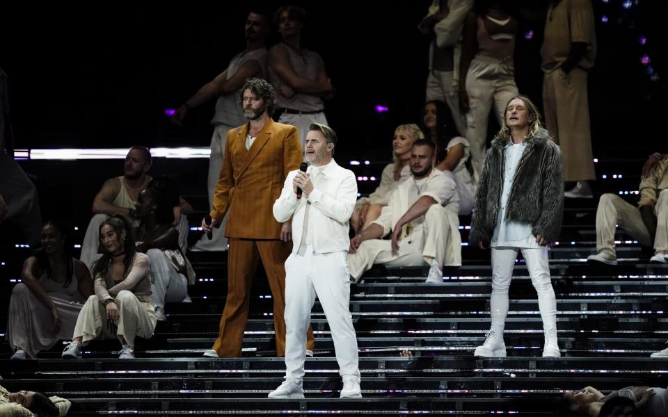 From left, Howard Donald, Gary Barlow and Mark Owen perform at BST Hyde Park in 2023