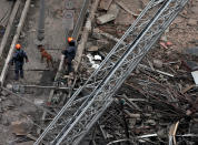 <p>Rescue workers along with sniffer dogs search for victims in a collapsed building in downtown Sao Paulo, Brazil May 1, 2018. (Photo: Leonardo Benassatto/Reuters) </p>