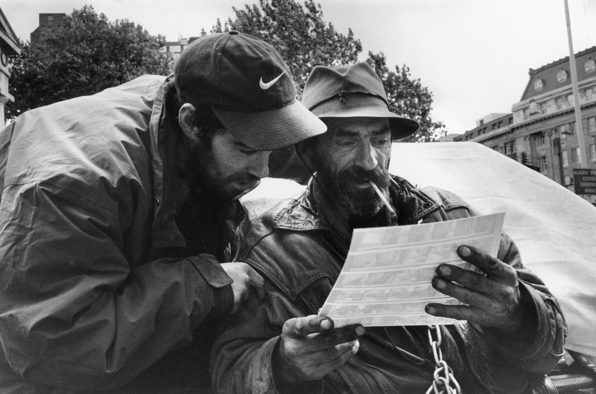 Zy and a friend looking at photos of themselves (Moyra Peralta/Courtesy of Bishopsgate Institute)