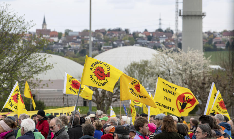Activists celebrate a shutdown party in front of the nuclear power plant 'Isar 2' in Neckarwestheim, Germany, Saturday, April 15, 2023. Germany is shutting down the last three nuclear power plants today as a part of an energy transition agreed by successive governments. (Stefan Puchner/dpa via AP)