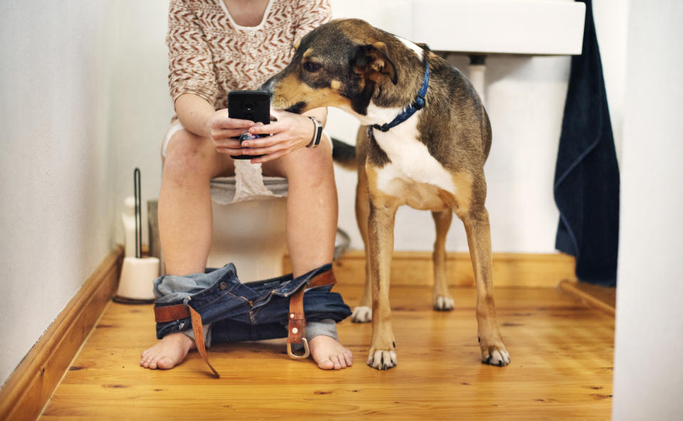 woman on phone while peeing