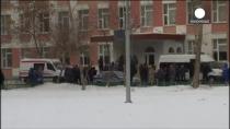 A Russian student has been detained after shooting dead a teacher and a police officer at a high school in Moscow. The gunman surrendered shortly after taking more than 20 other students hostage in a biology classroom. Authorities say he was armed with a rifle he obtained from his father, who helped police convince the teenager to give himself up. The drama took place at School No. 263 on the northern outskirts of the Russian capital. The shooting sent dozens of students scurrying out the school while a police helicopter landed in a snow-covered field outside. It comes despite a widespread rise in security just days before the start of the 2014 Winter Olympics in the Black Sea resort city of Sochi.