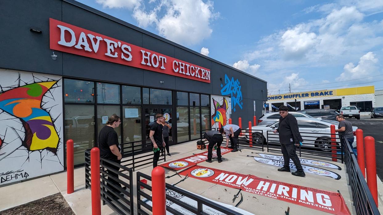 Employees works on preparing hiring signs at Dave's Hot Chicken on July 20, 2023.