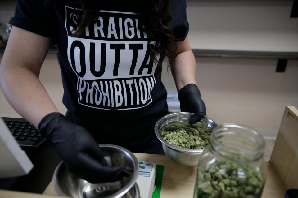 Angelica Quinonez, an employee of Ultra Health Dispensary, prepares cannabis products for sale on the historic day of recreational cannabis sale in Sunland Park, New Mexico, on April 1.