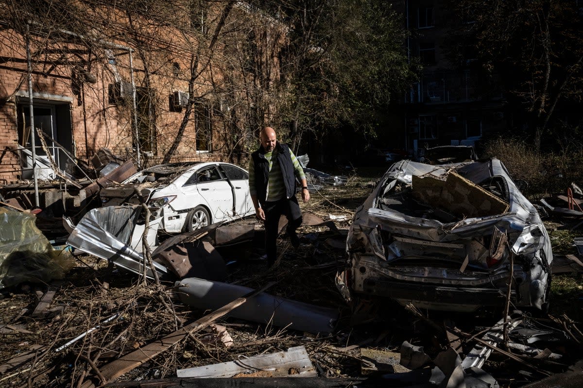 A Ukrainian man surveys the damage caused by a missile strike on a residential area near Kyiv's main train station (Getty)