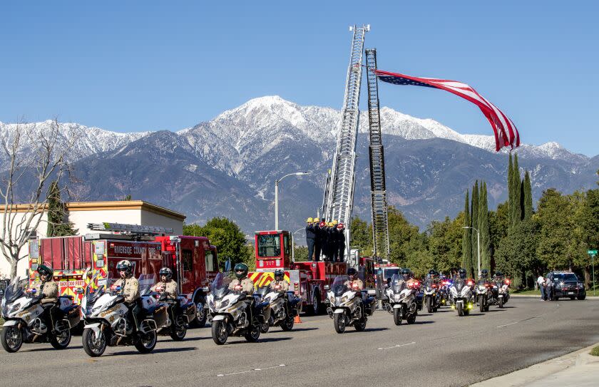 RANCHO CUCAMONGA, CA - JANUARY 21, 2023: Riverside County Sheriff motor deputies lead the funeral procession for fallen Riverside County Sheriff's Deputy Darnell Calhoun, 30, from the Abundant Living Family Church on January 21, 2023 in Rancho Cucamonga, California. Calhoun was killed in the line of duty answering a domestic violence call last week in Lake Elsinore.(Gina Ferazzi / Los Angeles Times)