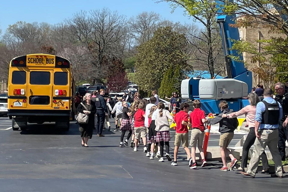 FILE - Children from The Covenant School, a private Christian school in Nashville, Tenn., hold hands as they are taken to a reunification site at the Woodmont Baptist Church after a deadly shooting at their school on March 27, 2023. Nearly a year after the shooting that left three adults and three children dead, the students and their families have formed tight bonds out of their shared suffering. (AP Photo/Jonathan Mattise, file)