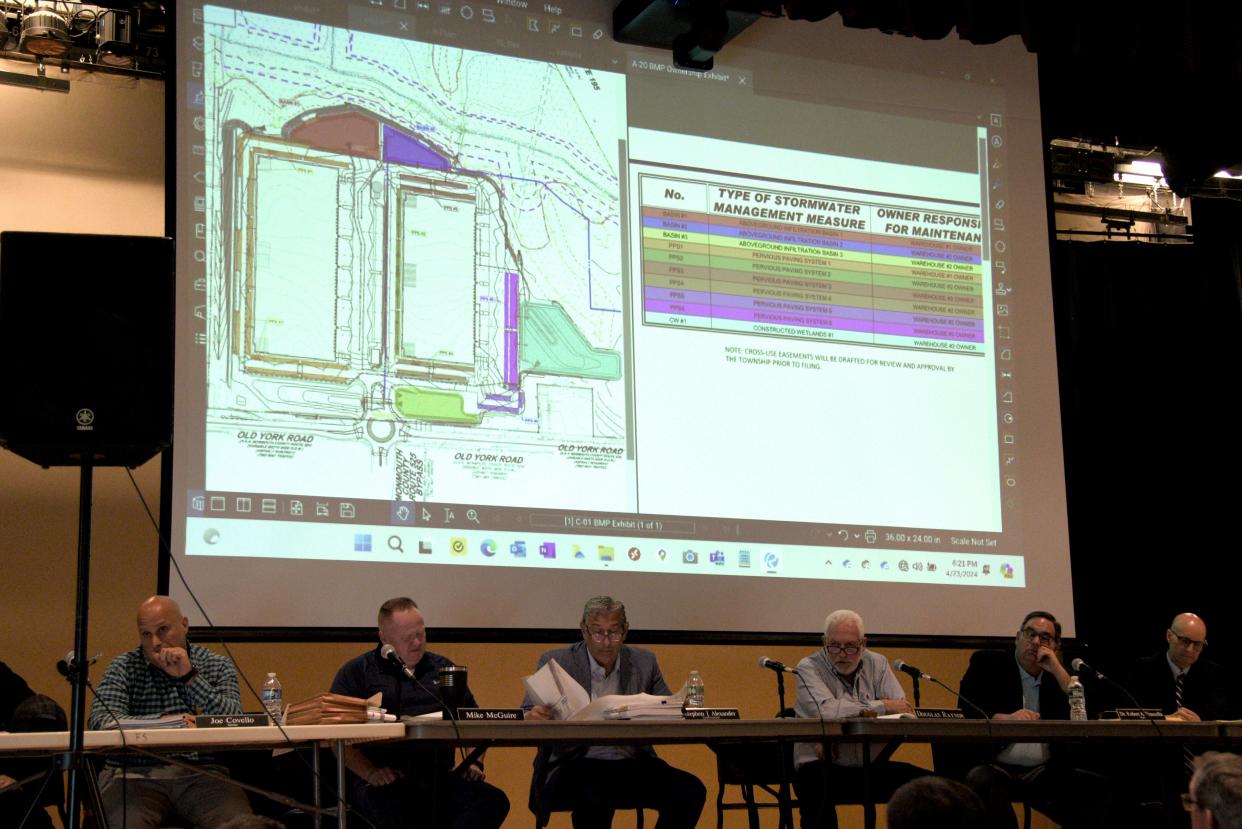 The Upper Freehold Planning board listens to the stormwater management proposal for the AAESAF warehouse on Tuesday, April 23, 2024 at the Stone Bridge Middle School in Upper Freehold, New Jersey.