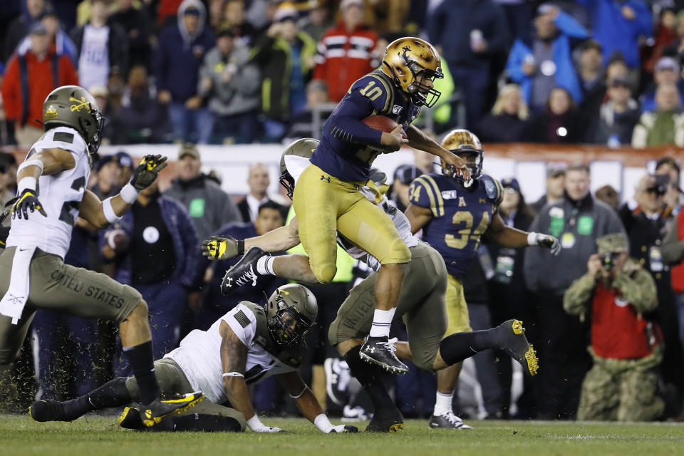 Navy's Malcolm Perry (10) leaps over Army's Donavan Lynch (11) during the second half on Saturday in Philadelphia. (AP Photo/Matt Slocum)