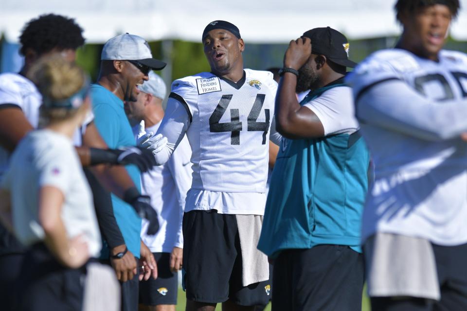 Jaguars' defensive coordinator Mike Caldwell (L) jokes around with outside linebacker Travon Walker (44), one of many new pieces that could help the Jaguars defense make significant improvement in 2022.