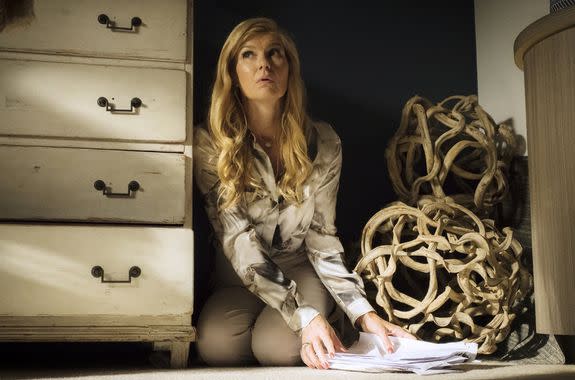 Connie Britton as Debra Newell, hiding from security cameras in her house.
