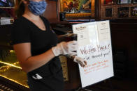 A sign welcomes customers in the dining room of San Pedro Brewing Company on Friday, May 29, 2020, in the San Pedro area of Los Angeles. Restaurants were allowed to open their dining rooms with restrictions today. (AP Photo/Ashley Landis)