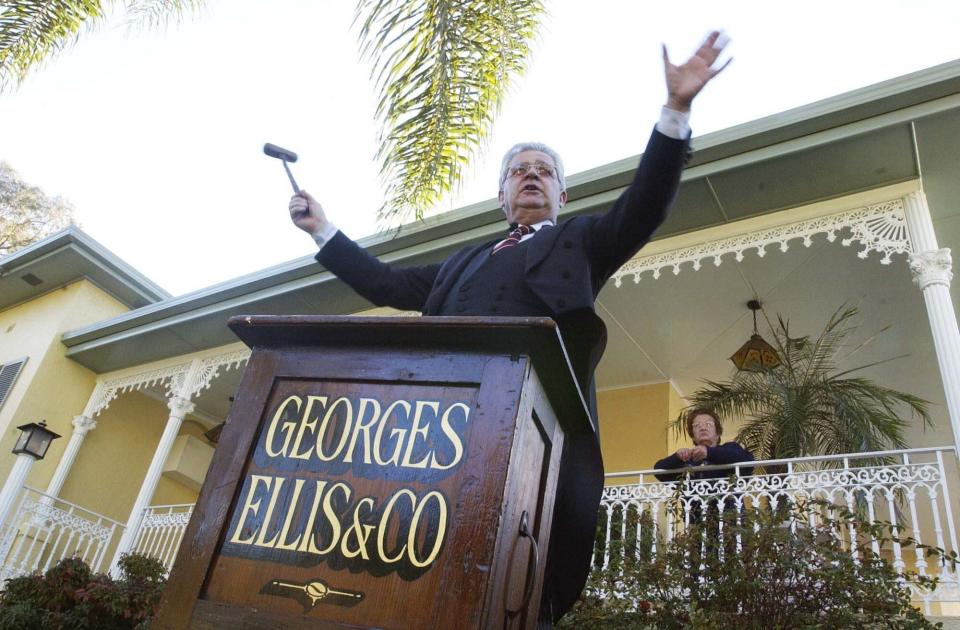 Sydney, August 02, 2003. Roger Ellis of real-estate agents Georges Ellis and Co, starts the bidding at an auction for the sale of a four-bedroom family residence in the Sydney suburb of Strathfield.  (AAP Image/Sam Mooy) 