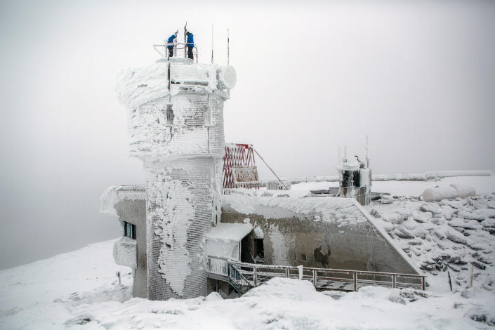 Mount Washington Observatory weather observers check on the weather instruments at the top of the observatory on the summit of Mount Washington, New Hampshire. <span class="copyright">Photo by Aram Boghosian for The Boston Globe via Getty Images</span>