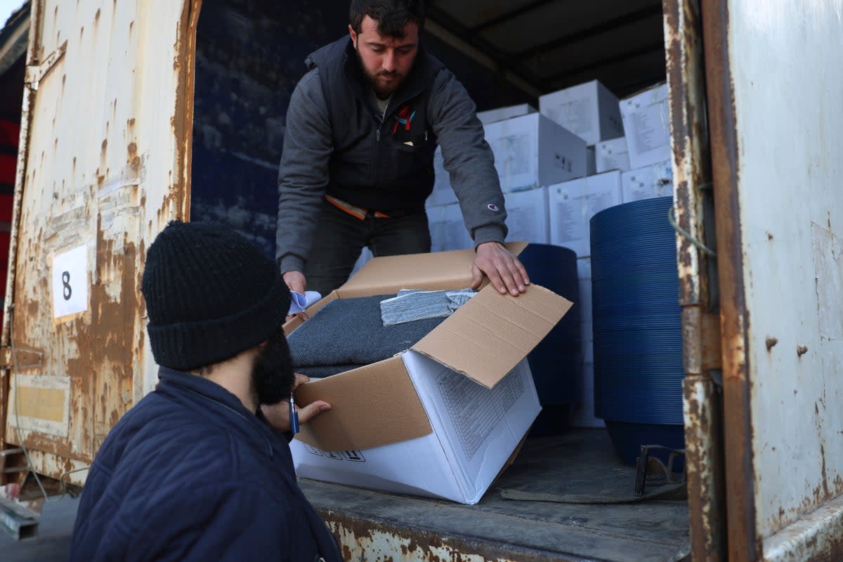 Border customs officials inspect a truck loaded with UN humanitarian aid for Syria (AP)