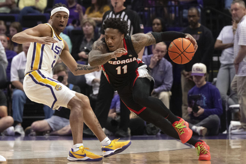 Georgia guard Justin Hill (11) drives the ball around LSU guard Mike Williams III (2) during an NCAA college basketball game Tuesday, Feb. 27, 2024, in Baton Rouge, La. (Hilary Scheinuk/The Advocate via AP)