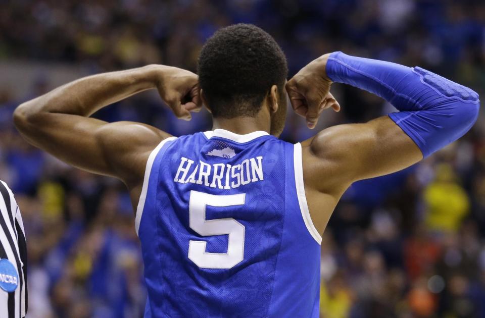 Kentucky's Andrew Harrison reacts during the first half of an NCAA Midwest Regional final college basketball tournament game against Michigan Sunday, March 30, 2014, in Indianapolis. (AP Photo/Michael Conroy)