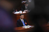 A cameraman films Chinese President Xi Jinping attending the second plenary session of the National People's Congress (NPC) at the Great Hall of the People in Beijing, Friday, March 8, 2024. (AP Photo/Andy Wong)
