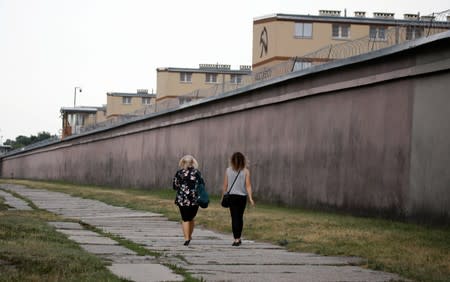 Women walk outside of the Bialoleka prison in Warsaw