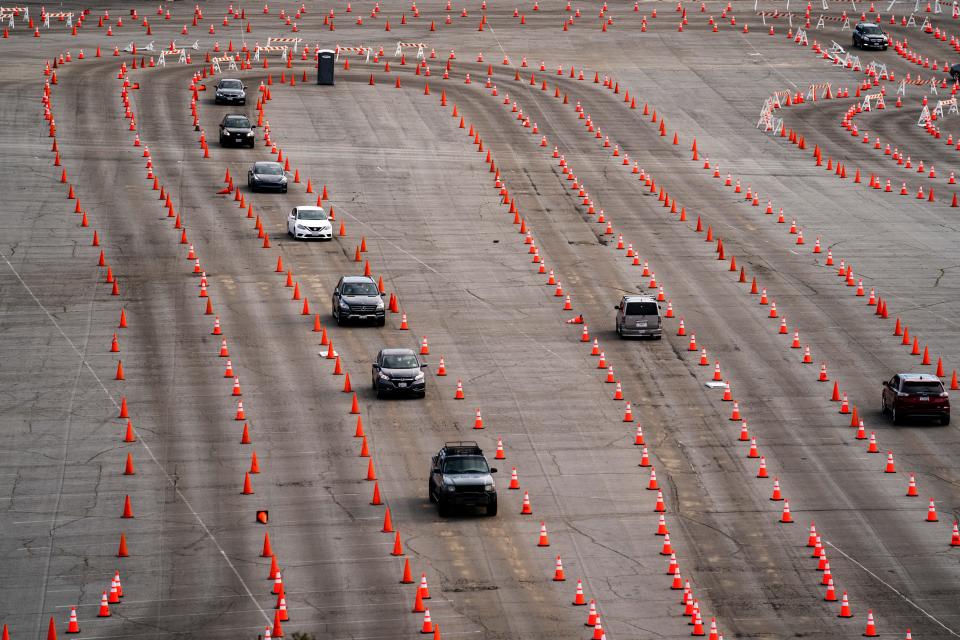 Traffic cones guide drivers into a COVID-19 mass vaccination site in the parking lot of Dodger Stadium in Los Angeles on Wednesday.