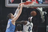 Los Angeles Clippers center Ivica Zubac (40) dunks over Minnesota Timberwolves forward Jarred Vanderbilt (8) during the first half of an NBA basketball game in Los Angeles Saturday, Nov. 13, 2021. (AP Photo/Kyusung Gong)