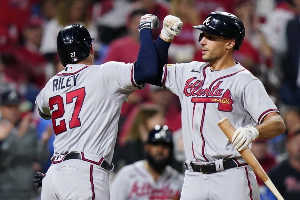 Atlanta Braves' Austin Riley celebrates his home run with Matt Olson after hitting a home run during the fourth inning of Game 4 of a baseball NL Division Series against the Philadelphia Phillies Thursday, Oct. 12, 2023, in Philadelphia. (AP Photo/Chris Szagola)