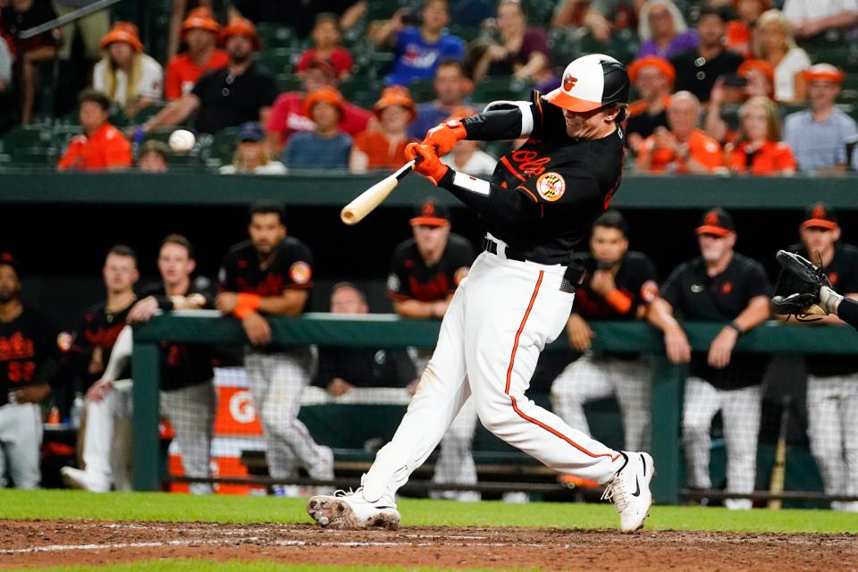 Baltimore Orioles' Adley Rutschman connects for an RBI single to score Rougned Odor during the ninth inning of a baseball game against the Los Angeles Angels, Friday, July 8, 2022, in Baltimore. The Orioles won 5-4. (AP Photo/Julio Cortez)