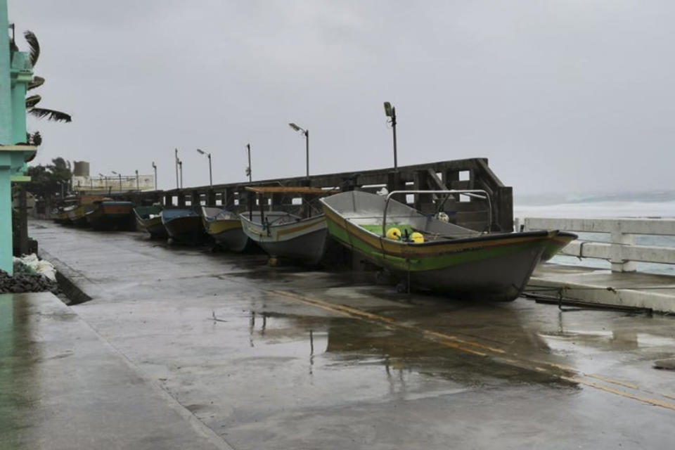 Boats lie along a road as villagers braced for the possible effects of Typhoon Mawar at Ivana, Batanes province, northern Philippines on Tuesday May 30, 2023. Typhoon Mawar lashed Taiwan's eastern coast with wind, rains and large waves Tuesday but largely skirted the island after giving a glancing blow to the northern Philippines. The storm was moving slowly toward southern Japan. (AP Photo/Juliet Cataluna)