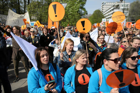 People hold banners during a rally to support a nationwide teachers' strike in central Warsaw, Poland April 24, 2019. Agencja Gazeta/Jedrzej Nowicki via REUTERS