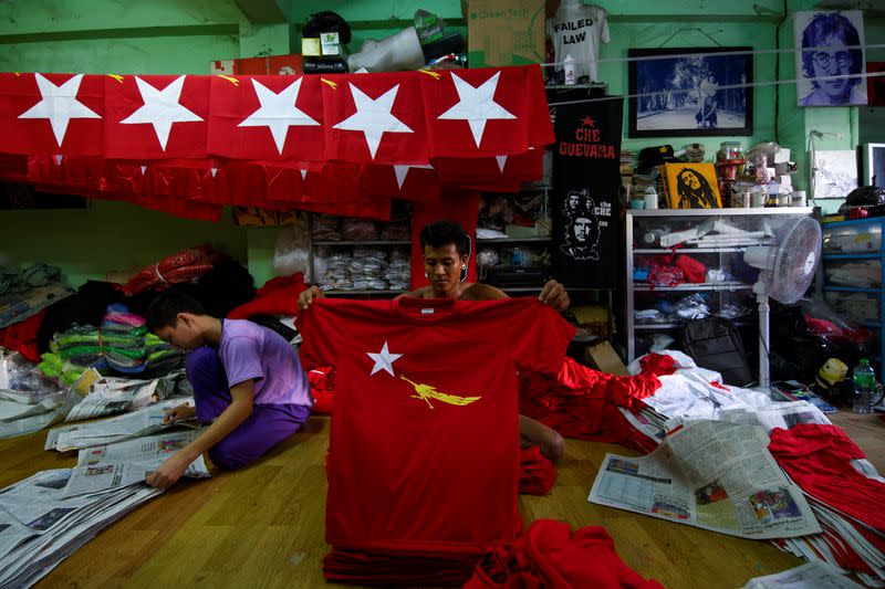 A worker prepares t-shirts with the logo of Aung San Suu Kyi's National League for Democracy NLD party in Yangon