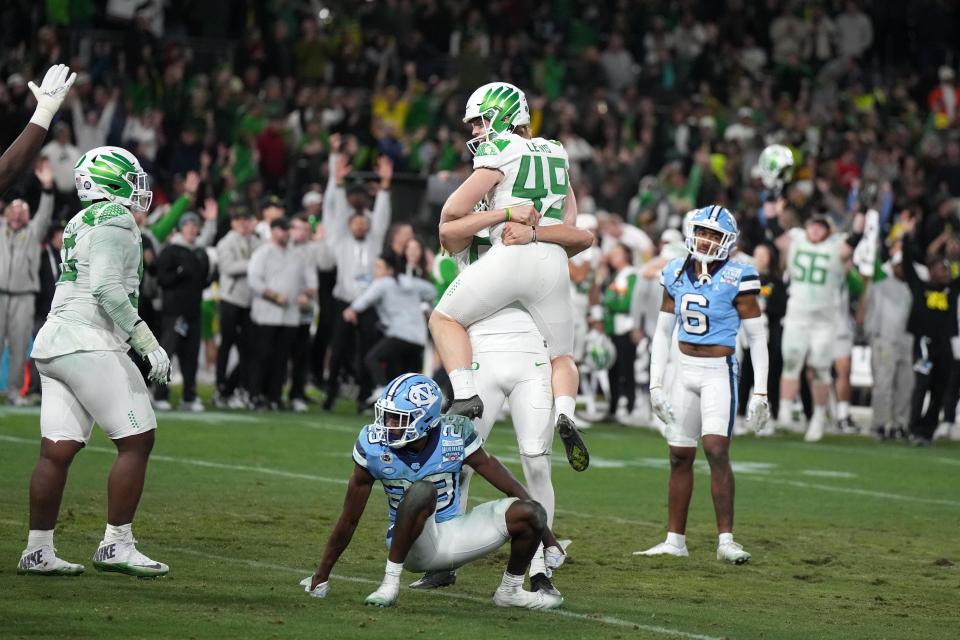 Dec 28, 2022; San Diego, CA, USA; Oregon Ducks place kicker Camden Lewis (49) celebrates with punter Adam Barry (93) after kicking an extra point in the fourth quarter of the 2022 Holiday Bowl against the North Carolina Tar Heels at Petco Park. Oregon defeated North Carolina 28-27. Mandatory Credit: Kirby Lee-USA TODAY Sports