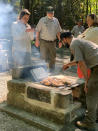 National Park Service employees cook chicken on a newly restored masonry grill at Shelter 3 at Grandview New River Gorge National Park and Preserve in West Virginia on Sept. 29, 2021. Work has begun on giving some of America’s most spectacular natural settings and historic icons a makeover. The Great American Outdoor Act was passed by Congress last year and dedicated up to $1.6 billion a year for the next five years to extensive maintenance and repairs that have been put off year after year. (Moira Gasior/National Park Service via AP)