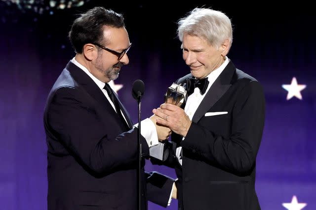 <p>Kevin Winter/Getty</p> Director James Mangold presents Harrison Ford with the Career Achievement Award at the 29th annual Critics Choice Awards.