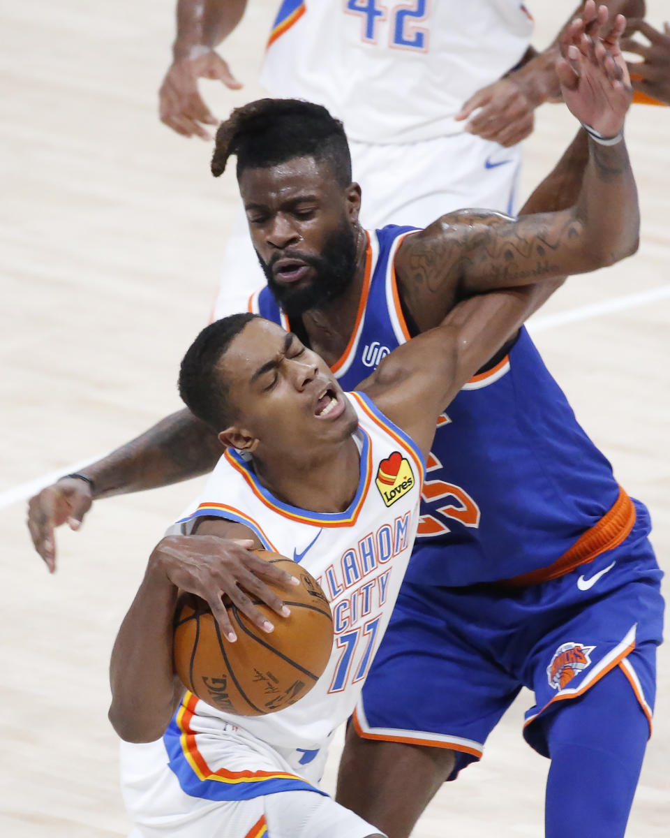 Oklahoma City Thunder guard Theo Maledon (11) is fouled by New York Knicks forward Reggie Bullock (25) during the first half of an NBA basketball game, Saturday, March 13, 2021, in Oklahoma City. (AP Photo/Garett Fisbeck)