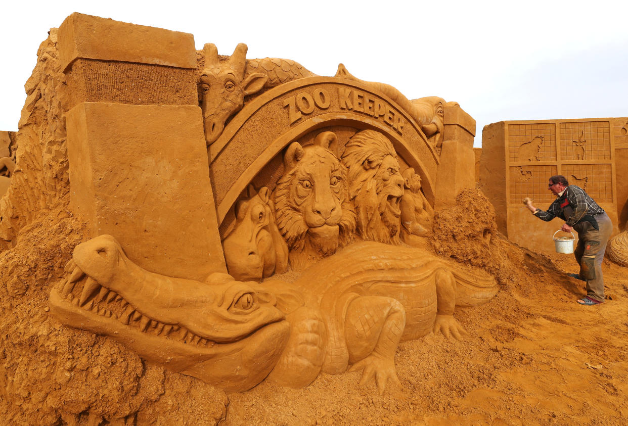 A sand carver works on a sculpture during the Sand Sculpture Festival "Dreams" in Ostend, Belgium June 18, 2019. (Photo: Yves Herman/Reuters)