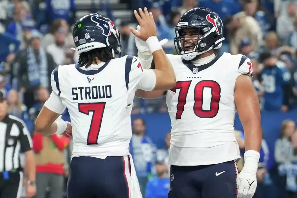 Houston Texans center Juice Scruggs, right, celebrates with quarterback C.J. Stroud, left, after Stroud’s 1-yard touchdown to fullback Andrew Beck on Saturday in Indianapolis.