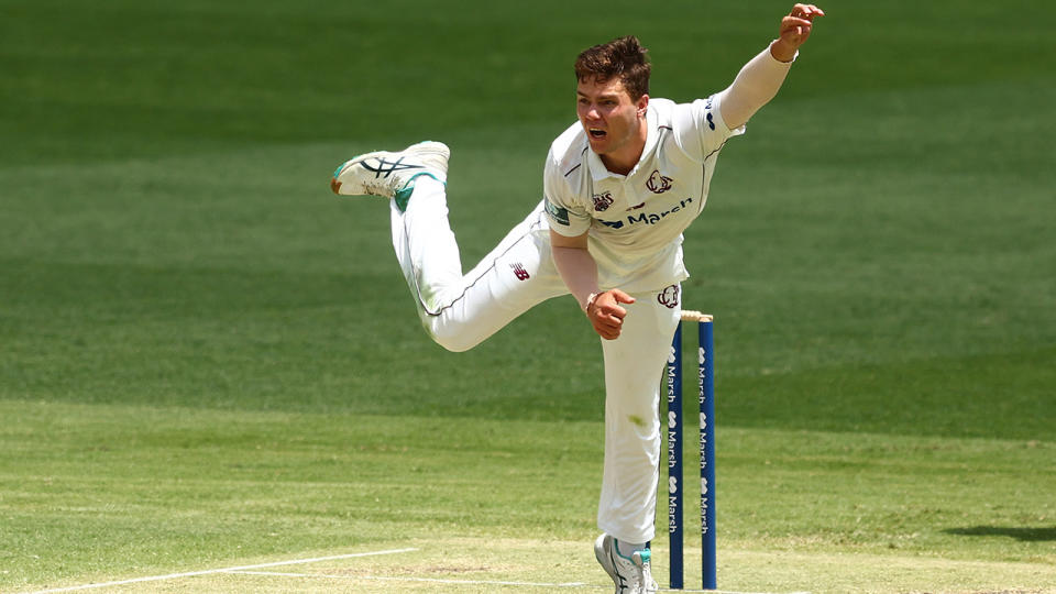 Mitchell Swepson bowls for Queensland in a Sheffield Shield match.