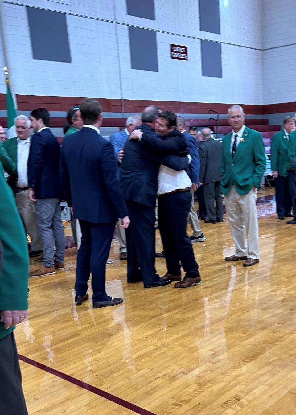 Members of the Savannah Saint Patrick's Day Parade Committee take turns congratulating John Forbes as the newly crowned Grand Marshal for the 200th anniversary of the parade.