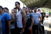 Cuban migrants wait in line for a meal at a temporary shelter in a school in the town of La Cruz, Costa Rica, near the border with Nicaragua, November 17, 2015. More than a thousand Cuban migrants hoping to make it to the United States were stranded in the border town of Penas Blancas, Costa Rica, on Monday after Nicaragua closed its border on November 15, 2015 stoking diplomatic tensions over a growing wave of migrants making the journey north from the Caribbean island. REUTERS/Juan Carlos Ulate