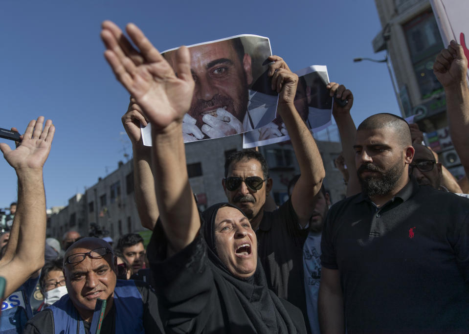 Maryam Banat, 67, mother of Palestinian Authority outspoken critic Nizar Banat chant ant Palestinian Authority slogans during a rally protesting his death, in the West Bank city of Ramallah, Saturday, July 3, 2021. Hundreds of Palestinians gathered to demonstrate against President Mahmoud Abbas, hoping to inject new momentum into a protest movement sparked by the death of an outspoken critic in the custody of security forces. (AP Photo/Nasser Nasser)