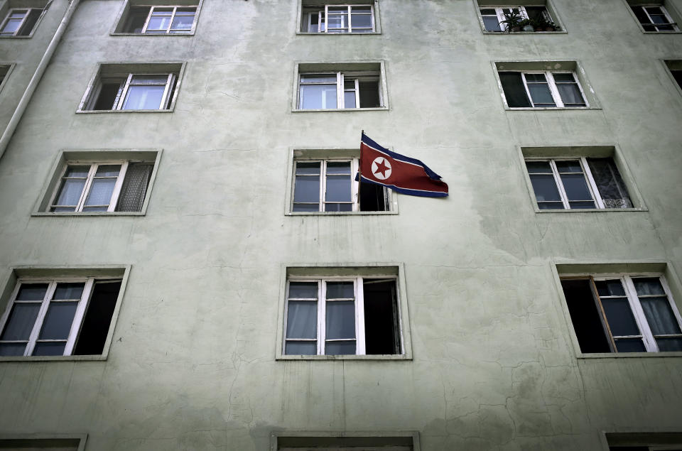 A North Korean national flag is hung out of a window of an apartment building, Sunday, July 27, 2014, in Pyongyang, North Korea. North Koreans gathered at Kim Il Sung Square Sunday as part of celebrations for the 61st anniversary of the armistice that ended the Korean War. (AP Photo/Wong Maye-E)