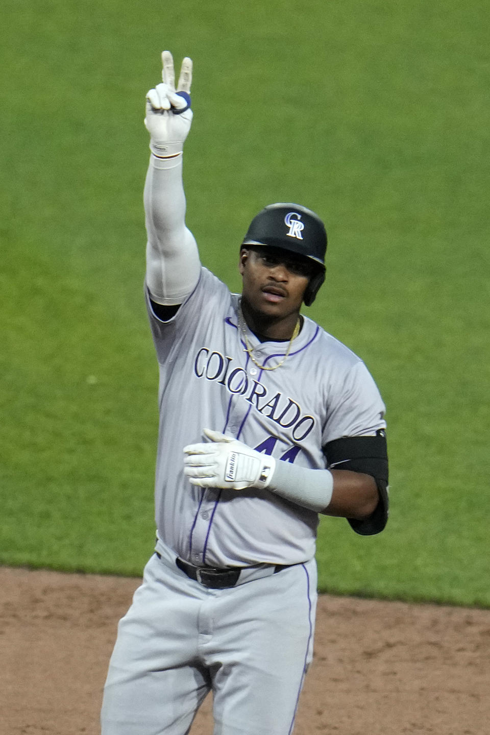 Colorado Rockies' Elehuris Montero celebrates as he stands on second base after driving in a run with a double off Pittsburgh Pirates starting pitcher Martín Pérez during the sixth inning of a baseball game in Pittsburgh, Friday, May 3, 2024. (AP Photo/Gene J. Puskar)
