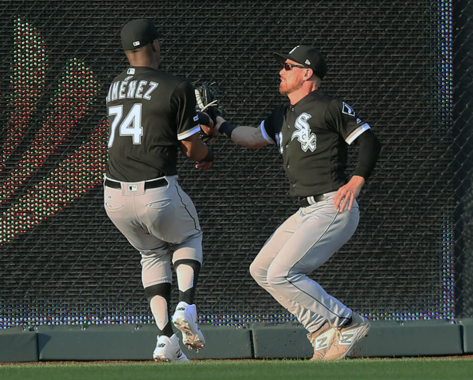 Chicago White Sox center fielder Charlie Tilson, right, collides with left fielder Eloy Jimenez (74) after catching a fly ball hit by Kansas City Royals right fielder Whit Merrifield during the first inning of a baseball game at Kauffman Stadium in Kansas City, Mo., Tuesday, July 16, 2019. Jimenez was injured on the play. (AP Photo/Orlin Wagner)