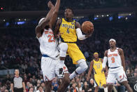 Indiana Pacers guard Victor Oladipo (4) goes to the basket against New York Knicks center Mitchell Robinson (23) in the first half of an NBA basketball game, Friday, Feb. 21, 2020, at Madison Square Garden in New York. (AP Photo/Mary Altaffer)
